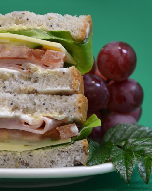 club sandwich on plate with grapes